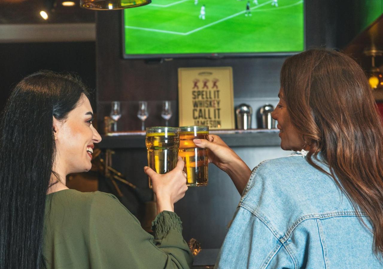 City Centre Rotana Doha Exterior photo Two women drinking beer