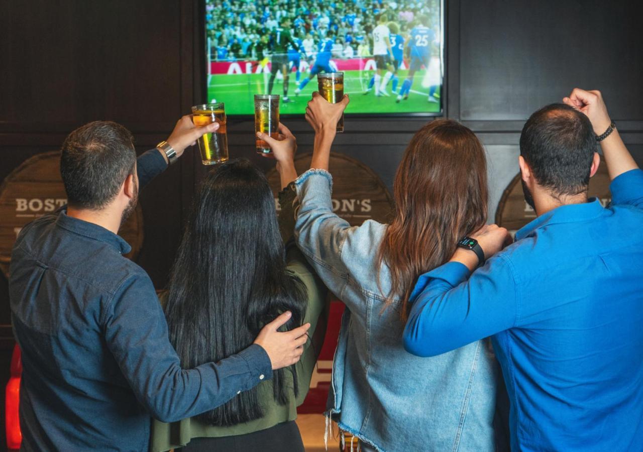 City Centre Rotana Doha Exterior photo Watching a match at a sports bar